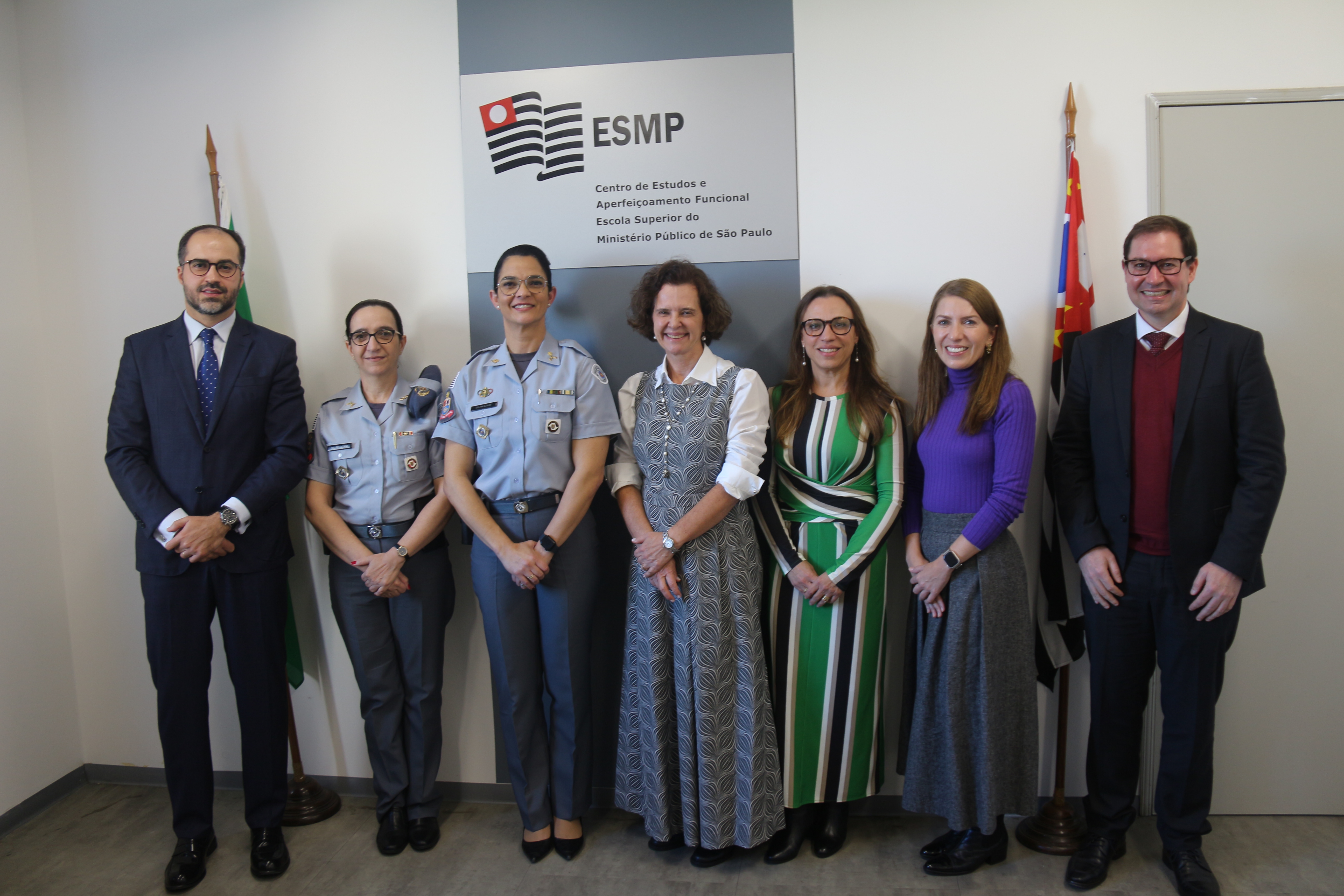 foto mostra a diretora da ESMPSP com demais participantes da reunião. Fim da descrição. 